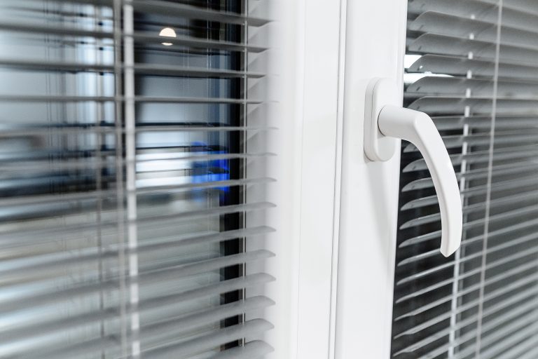 Aluminium blinds on the plastik window at home