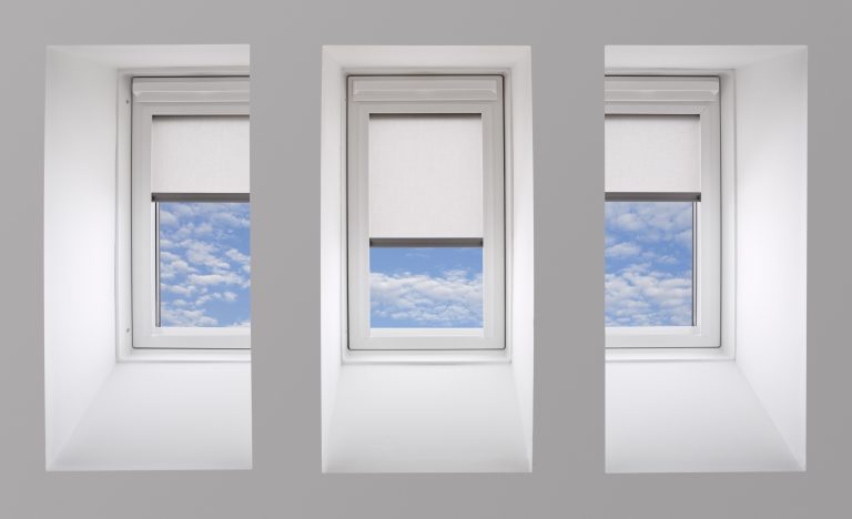 "a set of skylight windows in the slanting wall of a penthouse apartment, but equally can be from a wall in a loft or attic, or attic conversion (home improvement). Photographed relatively close up for effect. Three linen roller blinds have been lowered whilst through the window is a view towards a cloudy blue sky.Looking for a window Please see my window collection including cut-outs with clipping paths by clicking on the Lightbox Link below..."