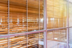 wooden blind behind the fixed glass window